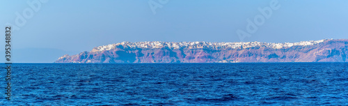 A view across the Caldera waters towards the northern tip of Santorini in summertime photo