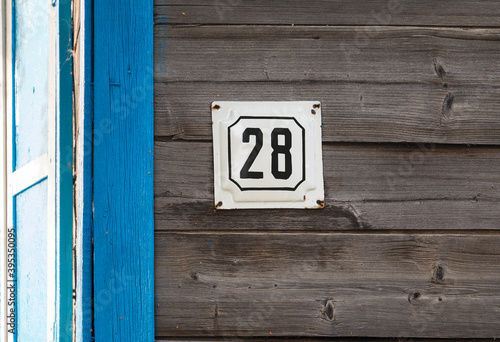 house number 28 on a wooden wall