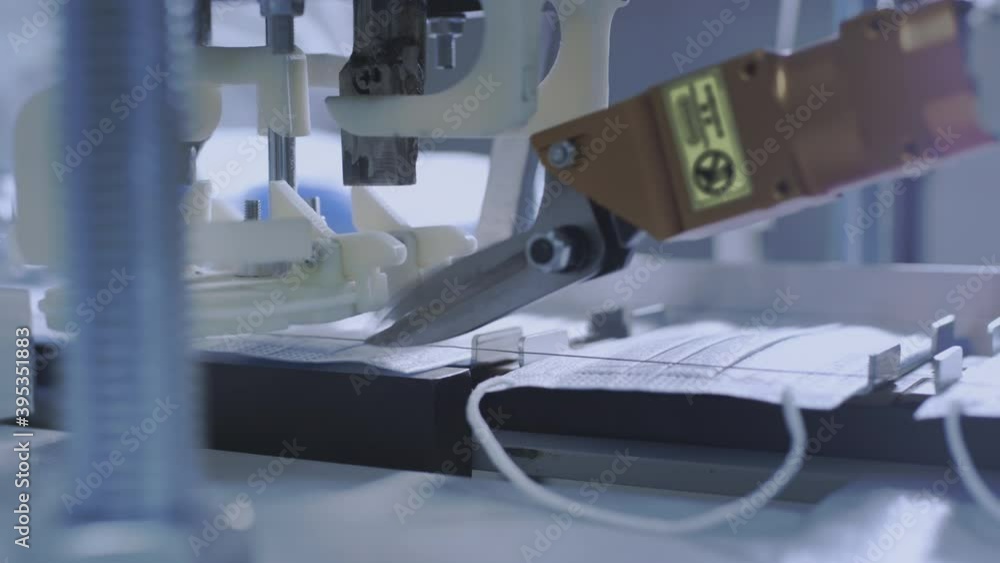 Production of medical protective face masks for air filtration. Coronavirus protection machine, covid-19. Steel scissors cut the thread to attach the mask to the face. Macro production line, conveyor. Production of medical protective face masks for air filtration. Coronavirus protection machine, covid-19. Steel scissors cut the thread to attach the mask to the face. Macro production line, conveyor.