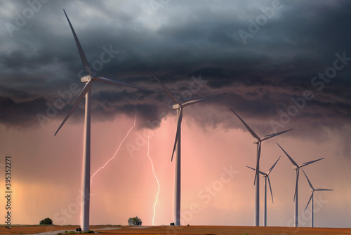 Modern windfarm located on farmland in midwest America during a lightening storm