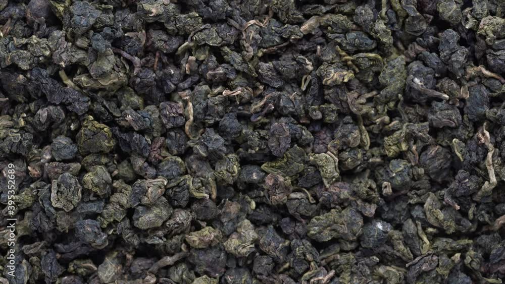 Green tea leaves background. Oolong tea rotates. Abstract food textures. Close up, top view. The high end tea of Vietnam Green tea leaves background. Oolong tea rotates. Abstract food textures. Close up, top view. The high end tea of Vietnam