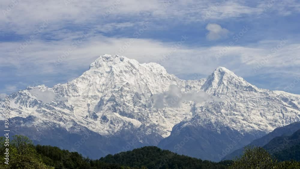 Himalayas Annapurna mountains snow high peak sunny day moving clouds sky timelapse panorama view, tourism outdoor adventure trekking, hiking, extreme climbing slope in national park Nepal. 4k footage Himalayas Annapurna mountains snow high peak sunny day moving clouds sky timelapse panorama view, tourism outdoor adventure trekking, hiking, extreme climbing slope in national park Nepal. 4k footage