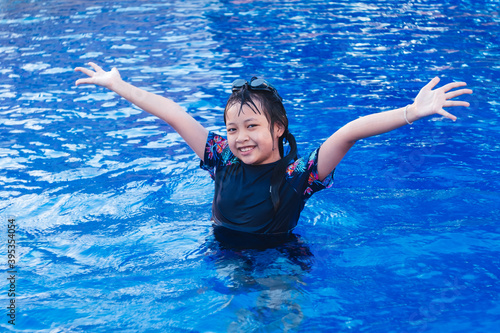 Freedom little girl in swimming pool with smile and happy