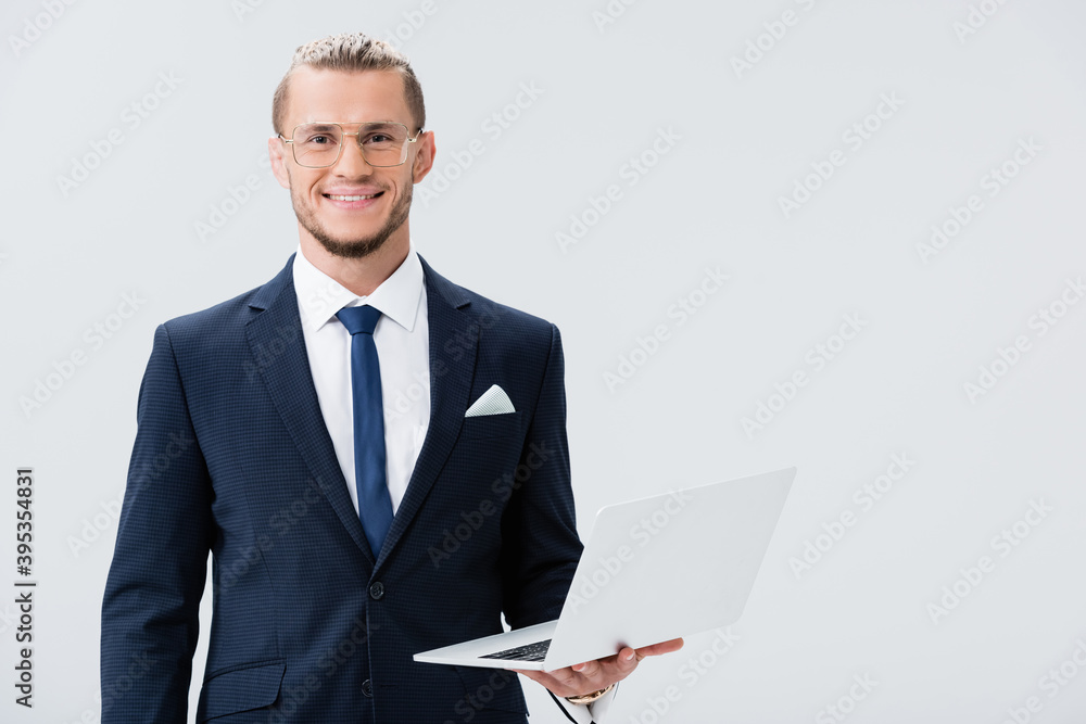 young businessman in suit and glasses with laptop isolated on white young businessman in suit and glasses with laptop isolated on white