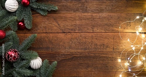 Wooden Christmas background with fir tree and Christmas lights with copy space for text or design
