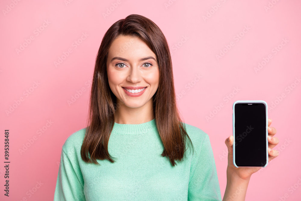 Photo of charming girl hold smartphone presenting screen empty space wear teal sweater isolated pink color background Photo of charming girl hold smartphone presenting screen empty space wear teal sweater isolated pink color background