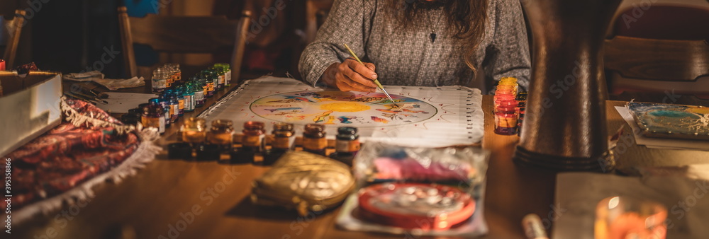 Man paints a beautiful picture on silk. Man paints a beautiful picture on silk.