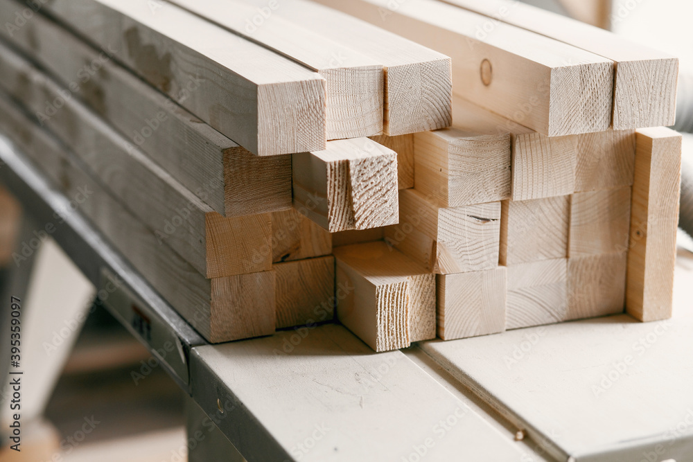 Wood timber construction material for background. Close up. Stack of wooden bars. Wood timber construction material for background. Close up. Stack of wooden bars.