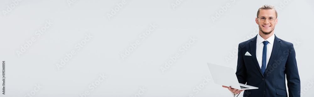 young businessman in suit and glasses with laptop isolated on white, banner young businessman in suit and glasses with laptop isolated on white, banner