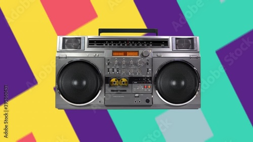 Retro music colourful background with radio boombox playing a golden cassette tape. Seamless loop