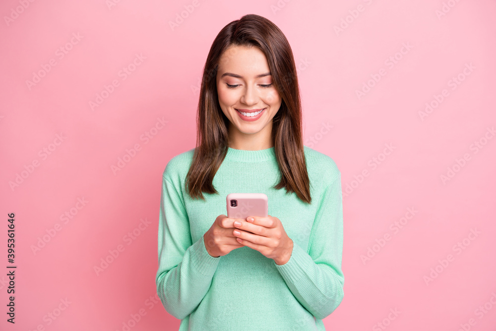 Photo of attractive person looking smartphone communicate teal pullover isolated on pink color background Photo of attractive person looking smartphone communicate teal pullover isolated on pink color background