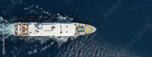 Aerial drone top down ultra wide panoramic photo of luxury yacht cruising in deep blue Aegean sea, Greece © aerial-drone