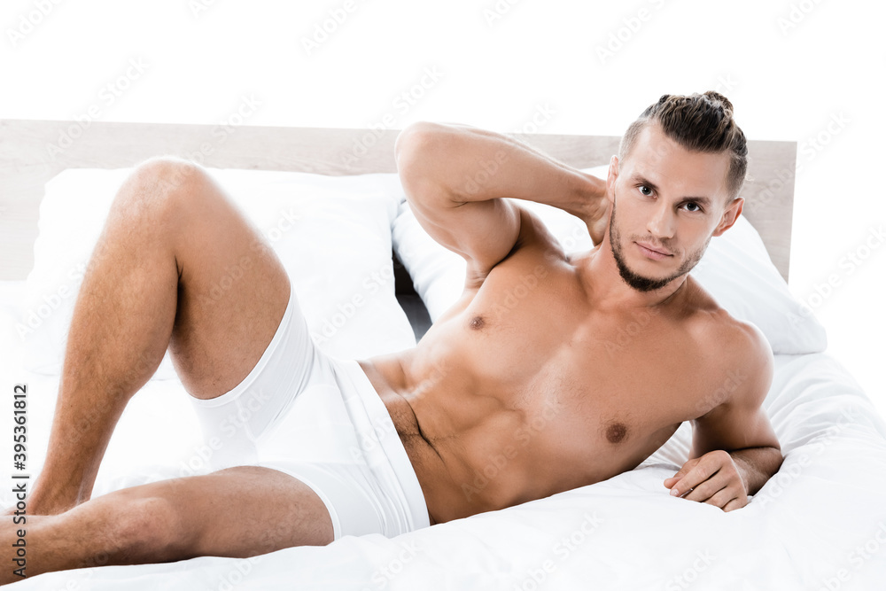 shirtless man lying in bed isolated on white shirtless man lying in bed isolated on white