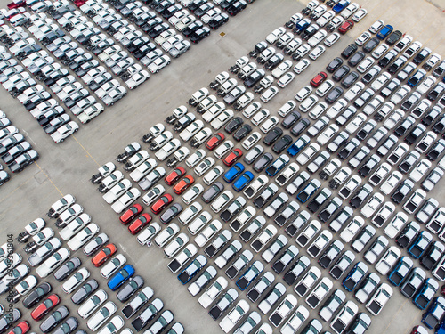 Aerial view rows of new cars waiting to be dispatch and shipped, New cars lined up in the port for import export.