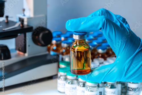 Doctor hands holding glass vial with medication