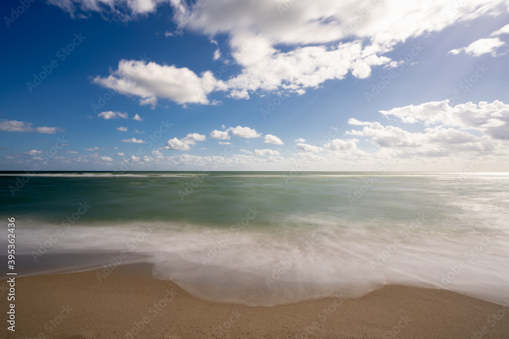 Beautiful 10 second long exposure photo waves crashing on the beach