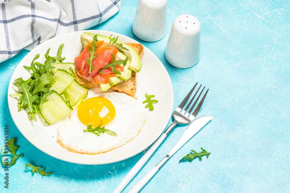 Breakfast. Fried egg, toast with salmon and avocado and fresh salad. Breakfast. Fried egg, toast with salmon and avocado and fresh salad.