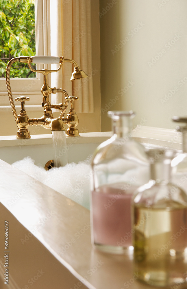 Bath Oil Bottles With Bubble Bathtub Stock Photo | Adobe Stock