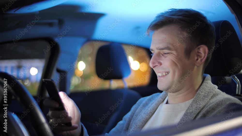 Online banking with smart phone. Handsome man in a car shopping with credit card using smartphone. The businessman made an electronic successful payment. E-commerce concept, savings and smart