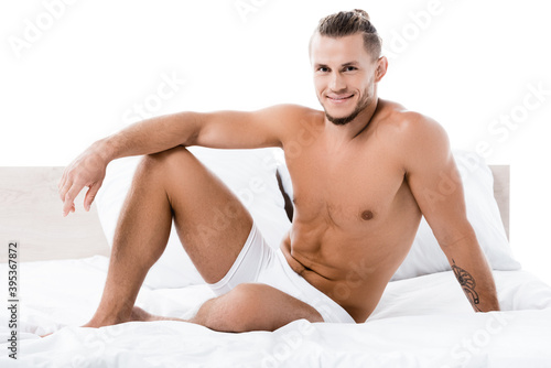  sexy shirtless man posing in bed isolated on white