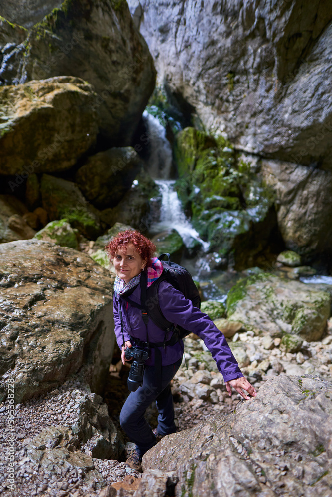 Tourist woman hiking in the mountains