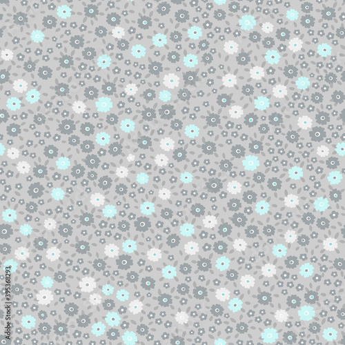 All over neutral retro ditsy floral seamless repeat pattern packed with many tiny small flowers and leaves in gray, blue and white colors