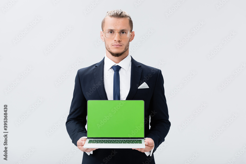 businessman in suit and glasses presenting laptop isolated on white businessman in suit and glasses presenting laptop isolated on white