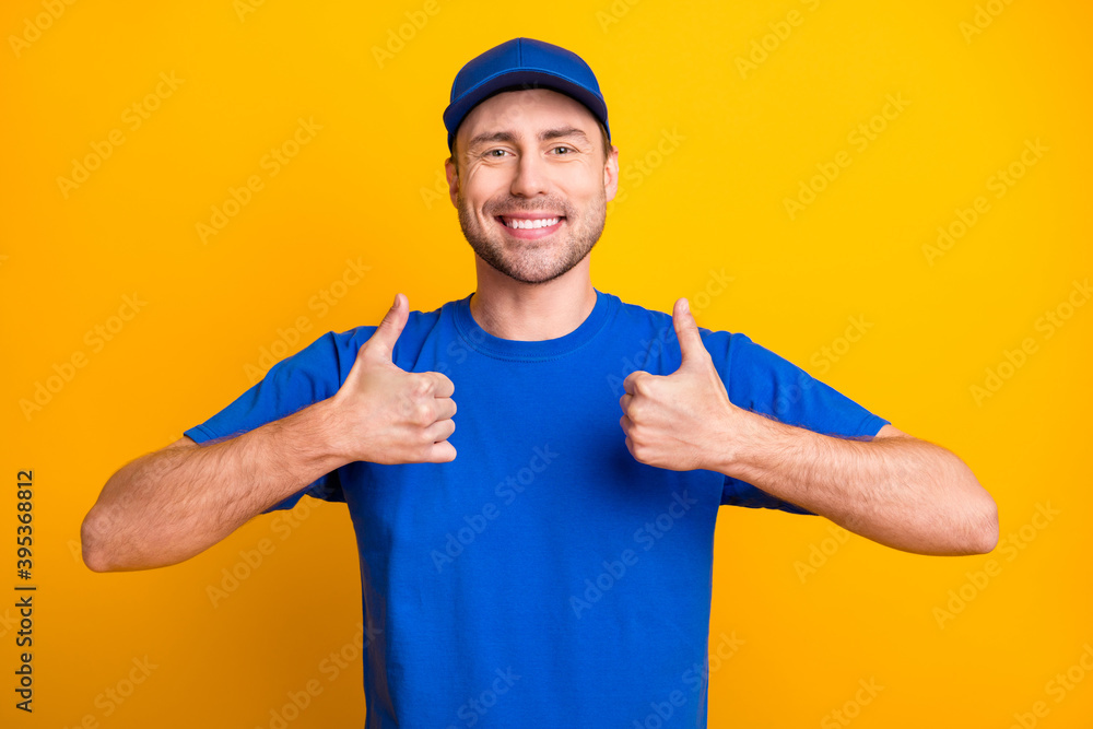 Portrait of cheerful handsome guy show two hands thumbs up toothy smile isolated on yellow color background