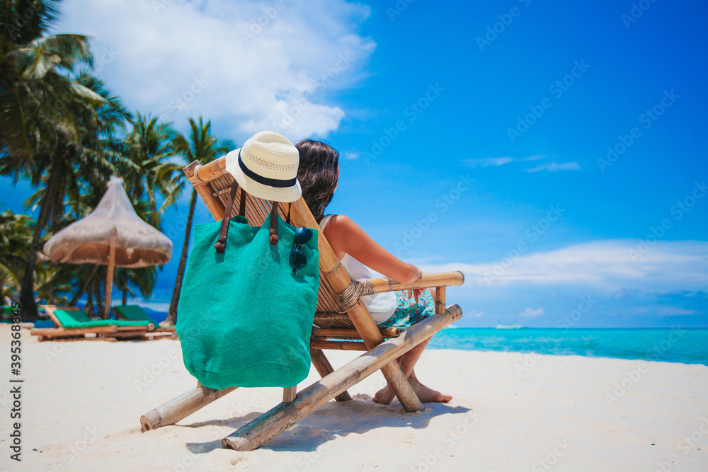 Woman laying on the beach enjoying summer holidays looking at the sea