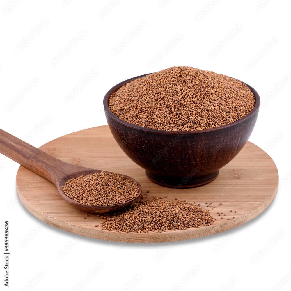 Yellow indian mustard seeds (Brassica juncea Czern) in brown bowl on wood board isolated on white background, copy space. Yellow indian mustard seeds (Brassica juncea Czern) in brown bowl on wood board isolated on white background, copy space.