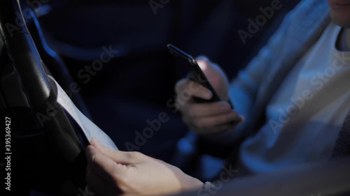 Close up of an asian young man scaning the receipts from stores with his mobile application in his car after work. Transferring money between accounts. QR Code Scanning, Saving Money, Deals, Coupons