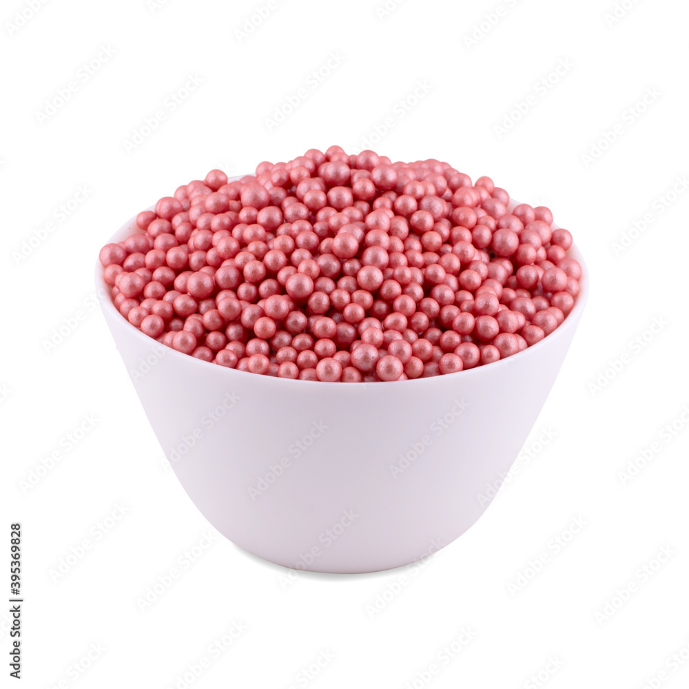 Pink sugar dragee in white bowl isolated on white background, copy space. Pink sugar dragee in white bowl isolated on white background, copy space.