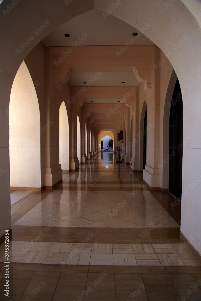 Perspective of the arcade with arches, columns and decorated floor, Muscat, Oman Perspective of the arcade with arches, columns and decorated floor, Muscat, Oman