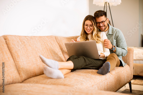 Young couple using laptop t...