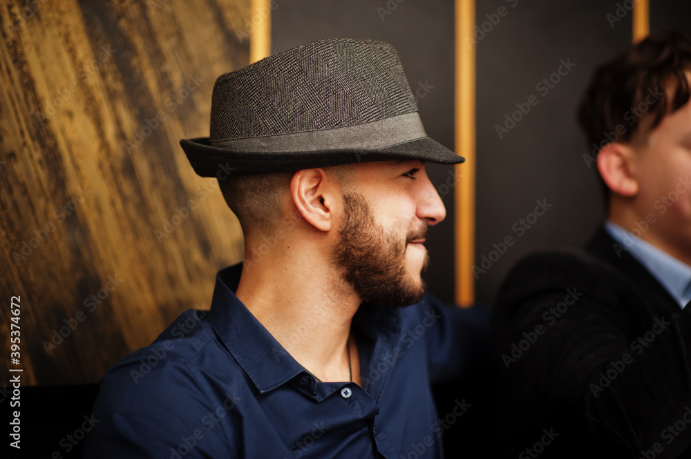Group of handsome retro well-dressed man gangsters spend time at club, smoking hookah. Multiethnic male bachelor mafia party in restaurant. Group of handsome retro well-dressed man gangsters spend time at club, smoking hookah. Multiethnic male bachelor mafia party in restaurant.