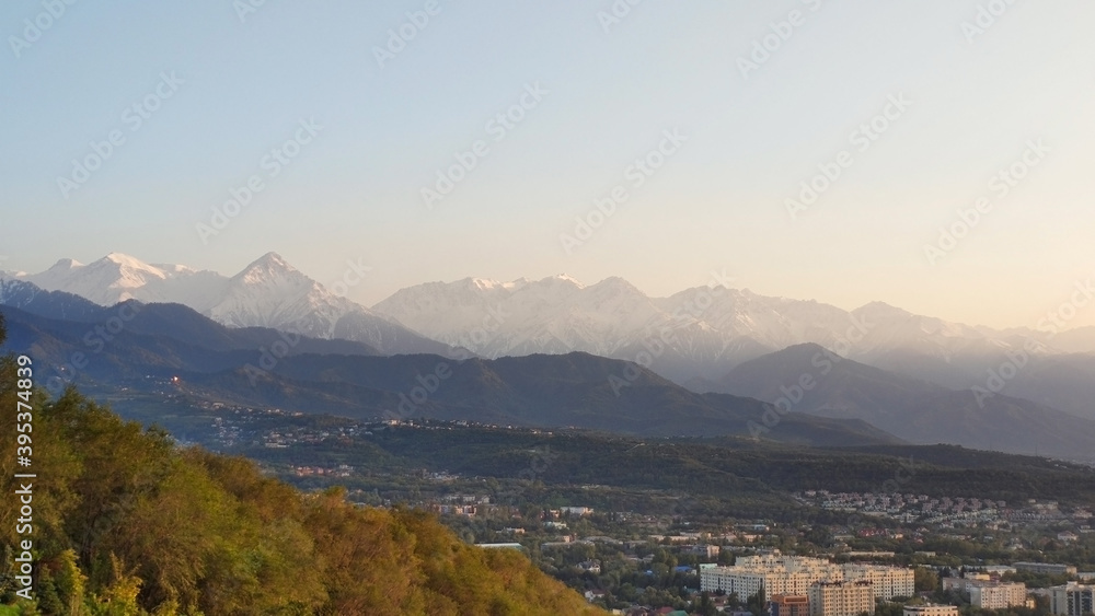 View from a height to the city of Almaty and snow mountains. Kazakhstan