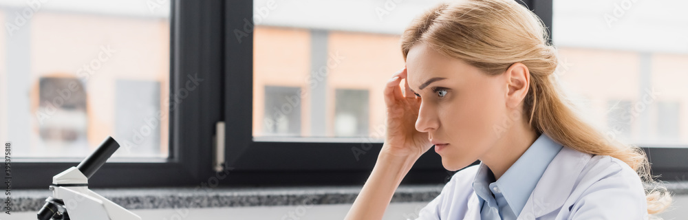 thoughtful scientist near microscope in lab, banner, stock image thoughtful scientist near microscope in lab, banner, stock image