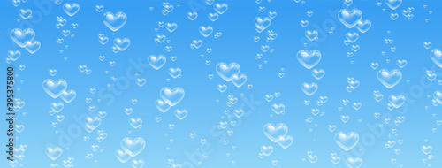 Heart shaped bubbles in water on blue background