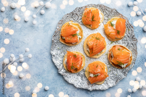 Tableau sur toile Blini with smoked salmon and sour cream, garnished with dill
