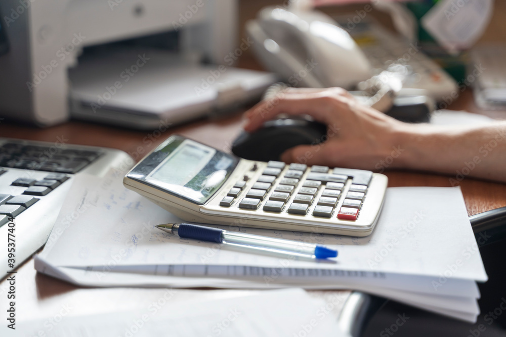 Girl at the Desk counts on a calculator, business concept Girl at the Desk counts on a calculator, business concept