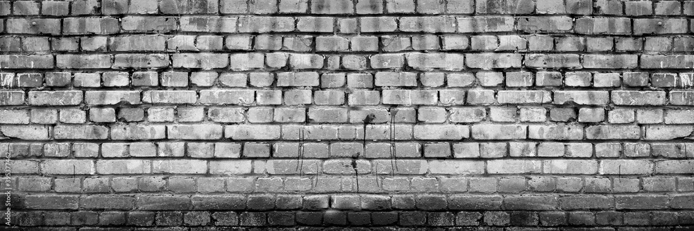 Fototapeta premium Grunge Grey White Brick Wall Background. Aged Wall Texture. Distressed Brickwork. Grungy Black Dark Stonewall Background.