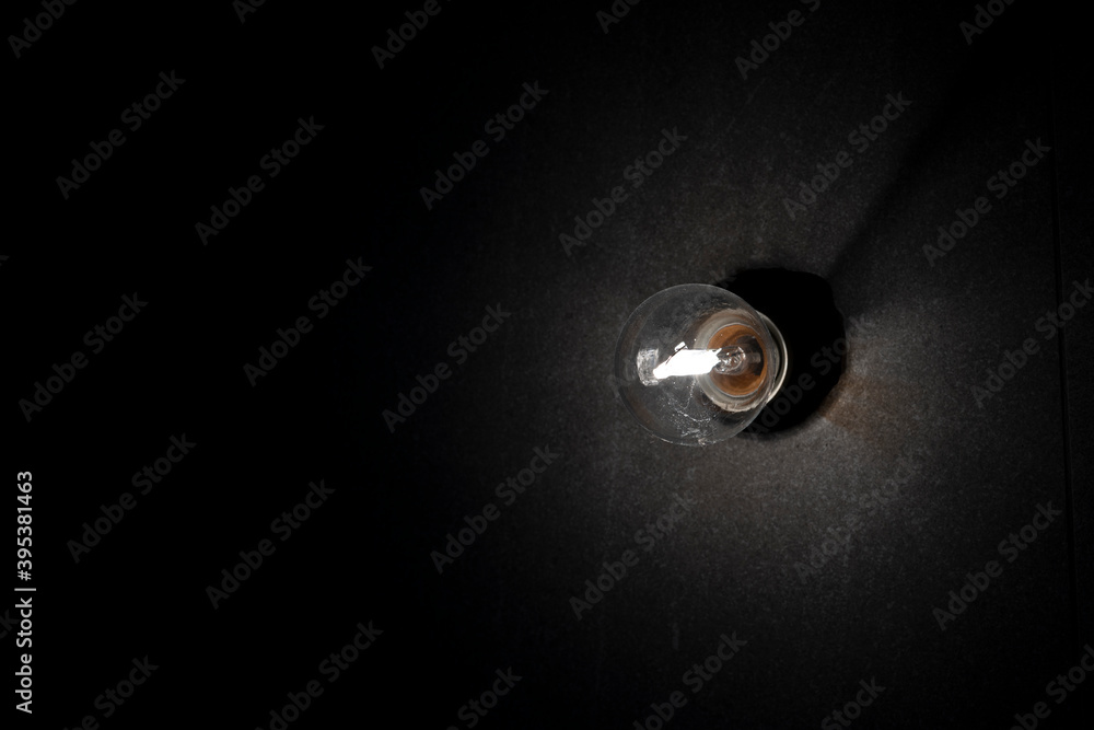 Background image of dark wall with lamp above.