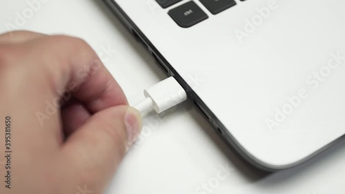 Hard disk connected to a laptop on white background
