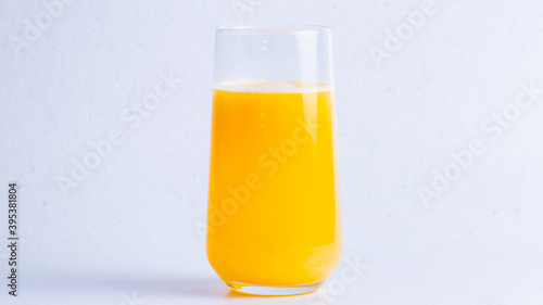 Healthy orange fresh juice in glass on a white background.