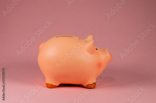 Close-Up Of pink Piggy Bank side Against Pink Background