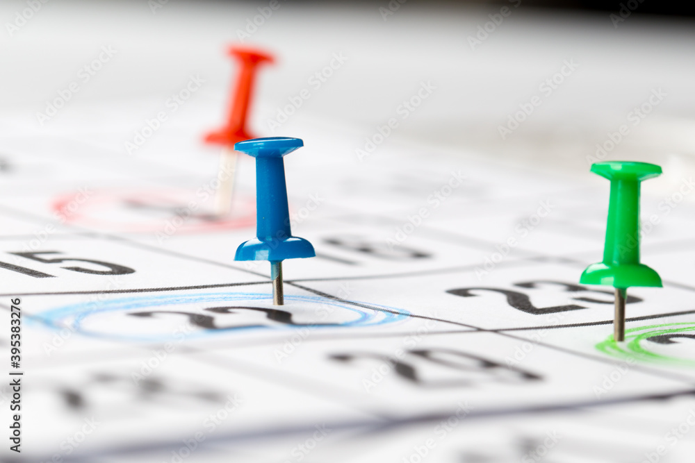 Thumbtack in calendar concept for busy, appointments and meeting reminders Thumbtack in calendar concept for busy, appointments and meeting reminders
