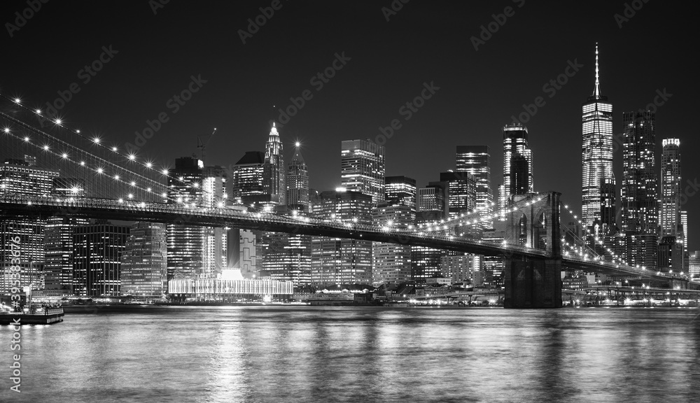 Black and white night view of Manhattan waterfront, New York City, USA.