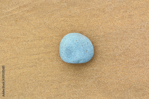 Sandy beach with stones in a postcard like iconic style photo