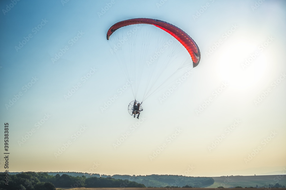 Paraglider in the air, beautiful blue sky in the background. Paraglider in the air, beautiful blue sky in the background.