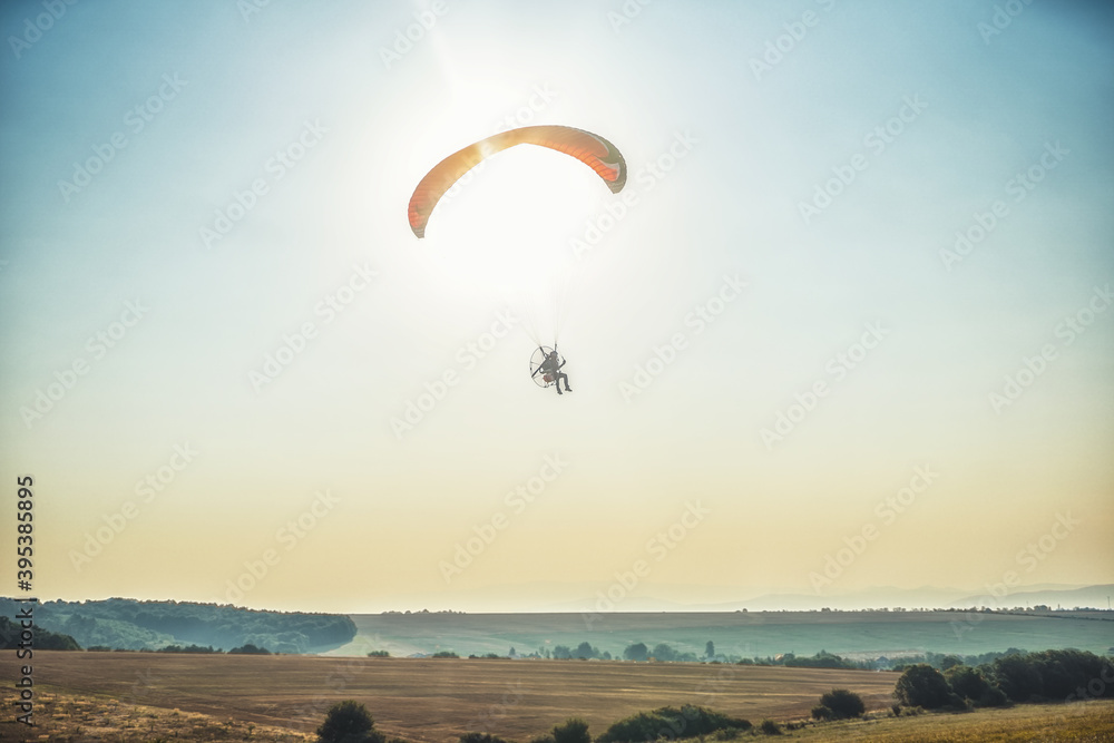 Paraglider in the air, beautiful blue sky in the background. Paraglider in the air, beautiful blue sky in the background.